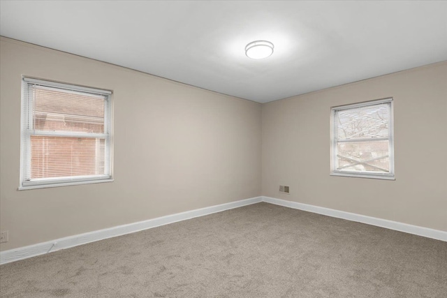 unfurnished room featuring carpet