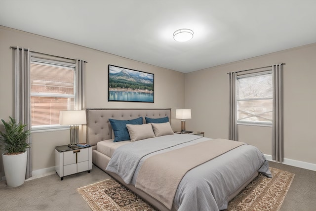 bedroom with multiple windows and light colored carpet