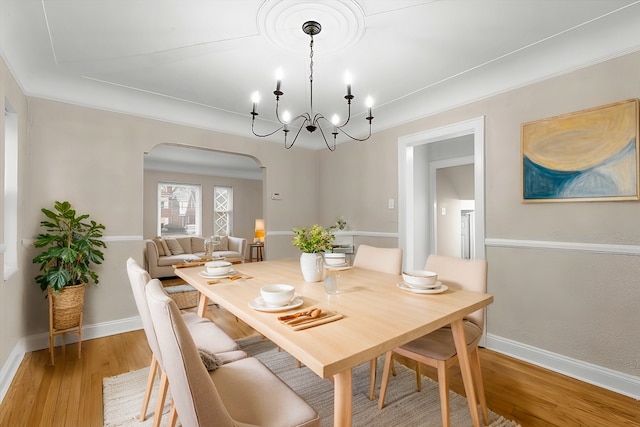 dining area featuring ornamental molding and wood-type flooring