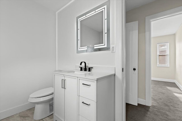 bathroom with toilet and vanity