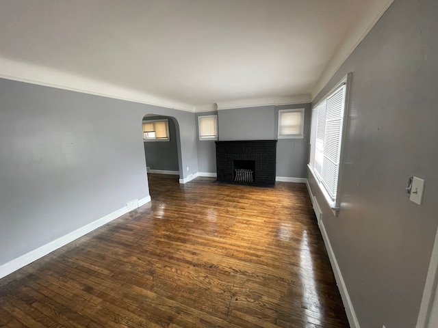 unfurnished living room with dark wood-type flooring and a fireplace