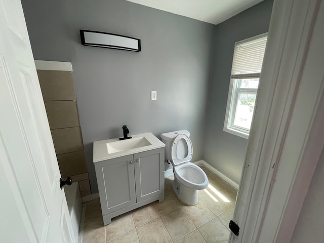 bathroom with vanity, toilet, and tile patterned flooring