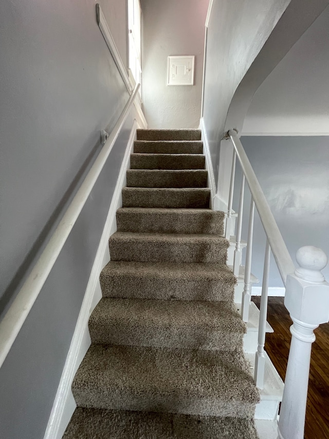 staircase with hardwood / wood-style flooring