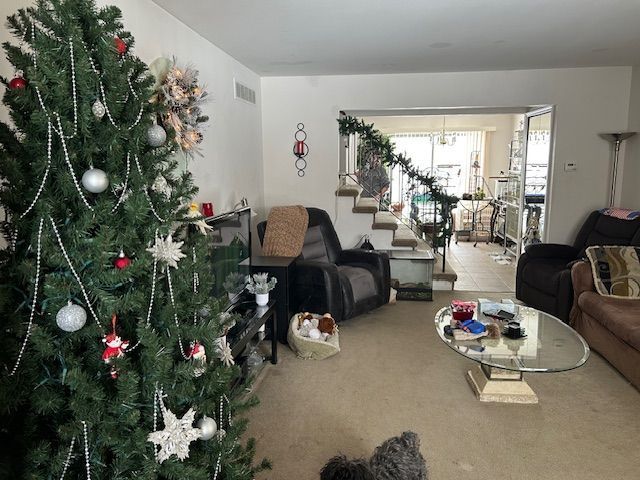 living area with stairway and visible vents