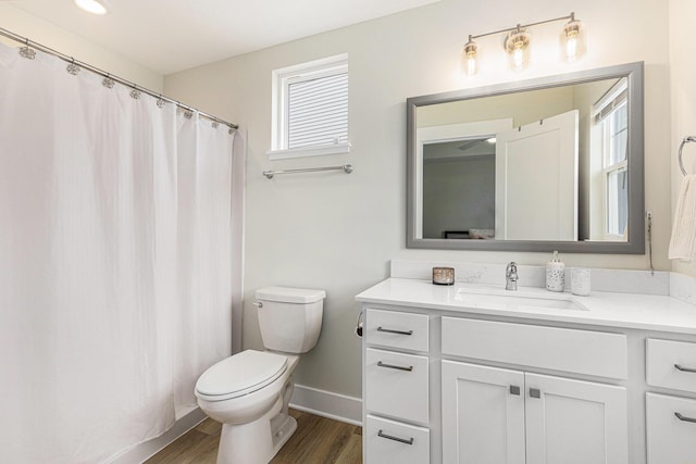 bathroom with hardwood / wood-style flooring, vanity, and toilet