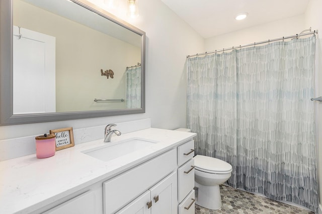 bathroom featuring vanity, toilet, and a shower with shower curtain