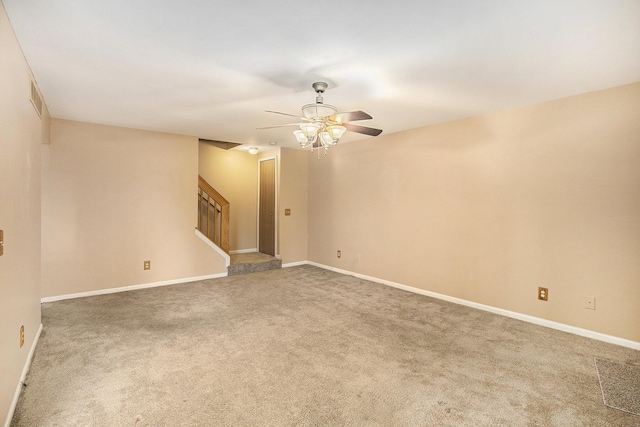 empty room featuring ceiling fan and carpet