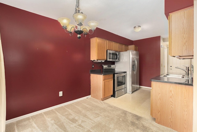 kitchen with pendant lighting, sink, an inviting chandelier, stainless steel appliances, and light carpet