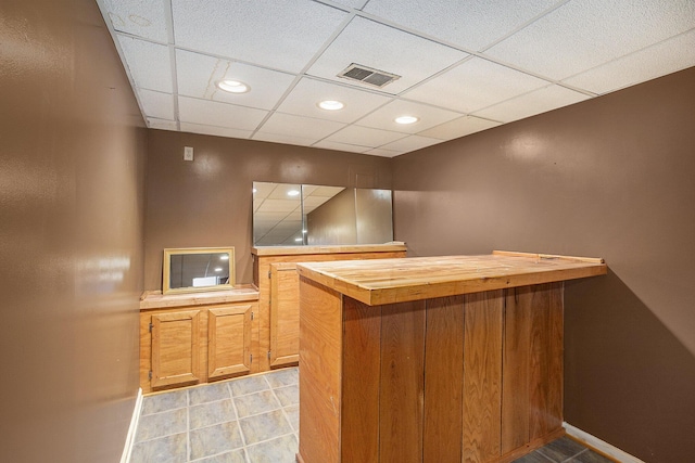 bar with wood counters and a drop ceiling