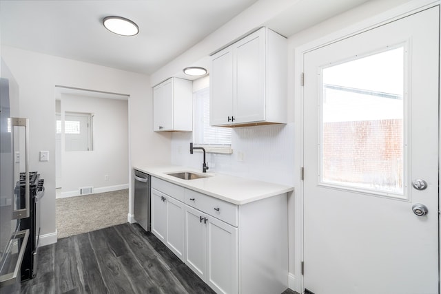 kitchen featuring stainless steel dishwasher, sink, white cabinetry, and dark hardwood / wood-style flooring