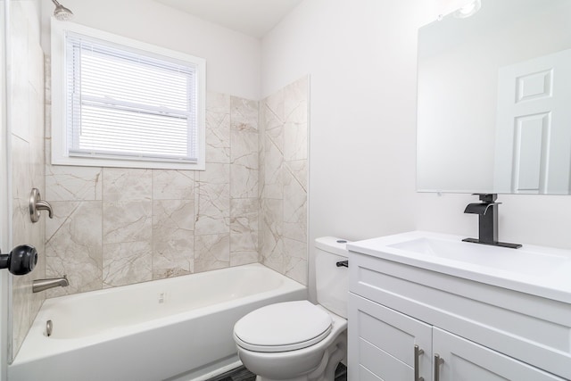 full bathroom with vanity, tiled shower / bath, and toilet