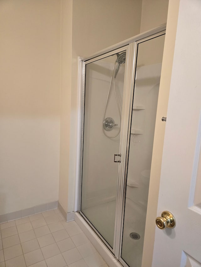 bathroom featuring a shower with door and tile patterned floors