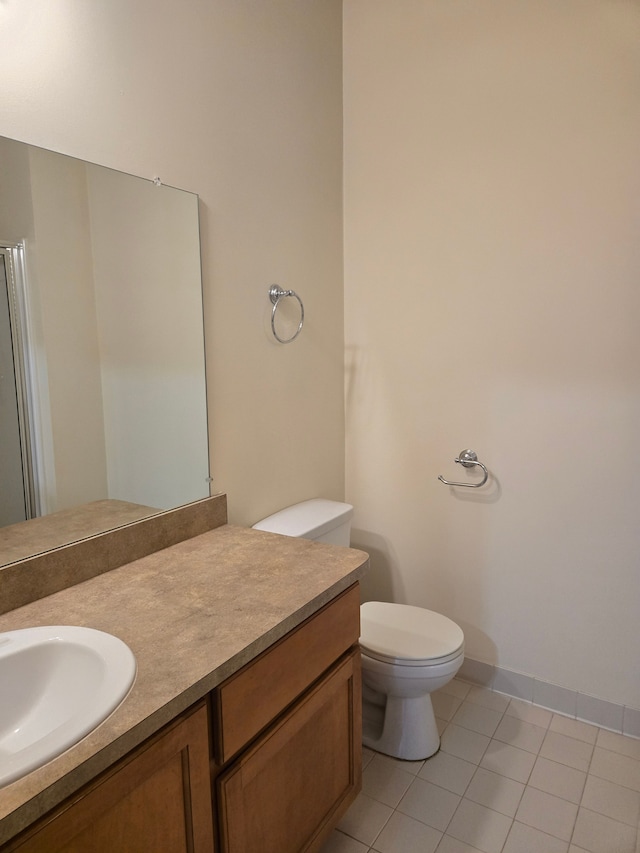 bathroom featuring vanity, toilet, and tile patterned flooring