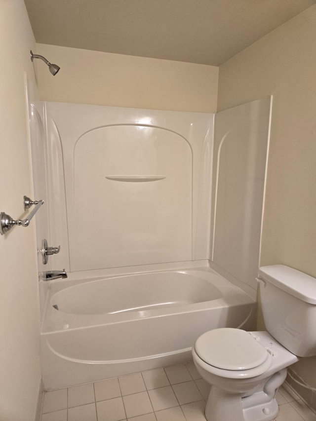 bathroom featuring tile patterned flooring, tub / shower combination, and toilet