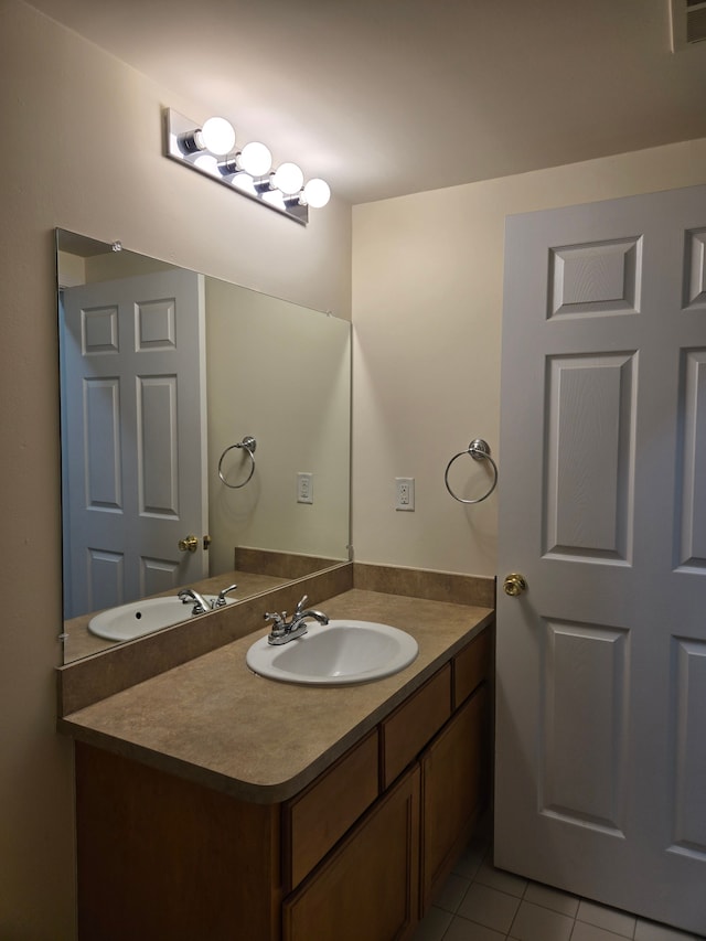 bathroom with tile patterned floors and vanity