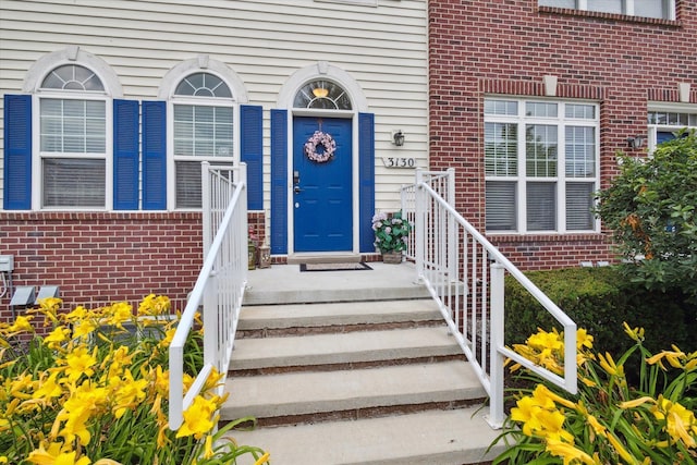 property entrance featuring brick siding