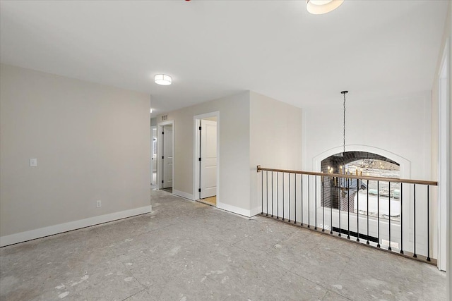 spare room featuring visible vents, baseboards, and an inviting chandelier