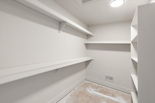 spacious closet featuring visible vents