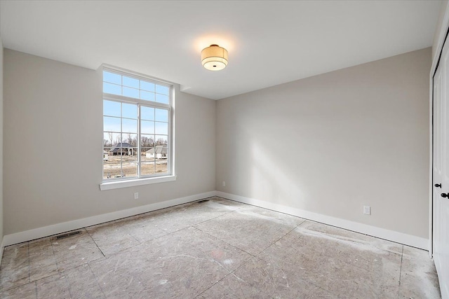 empty room featuring visible vents and baseboards