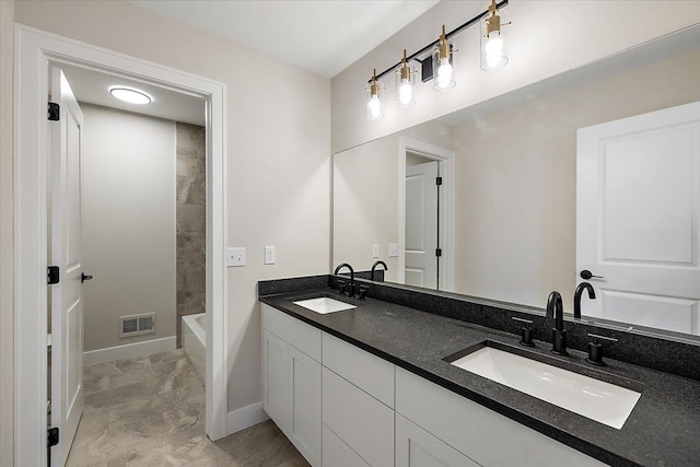 full bath featuring visible vents, a sink, baseboards, and double vanity