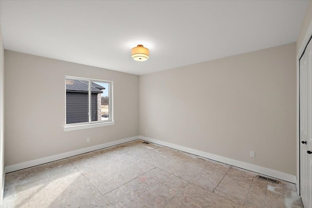 empty room featuring visible vents and baseboards