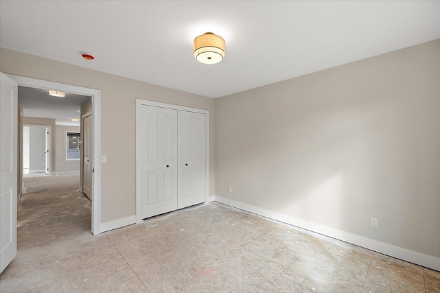 unfurnished bedroom featuring a closet and baseboards