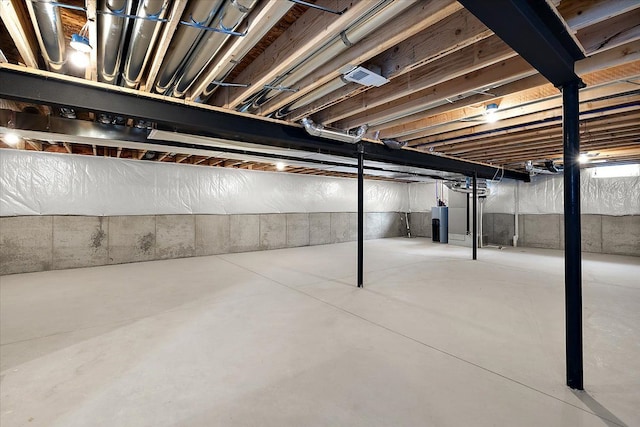 unfinished basement featuring water heater