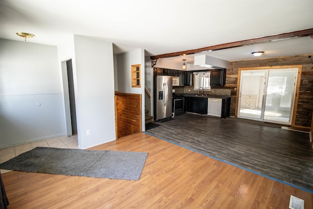 kitchen with stainless steel appliances, sink, and light hardwood / wood-style flooring