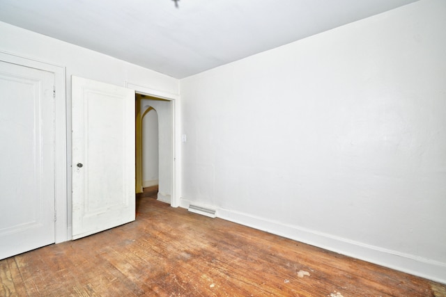 unfurnished bedroom with hardwood / wood-style flooring