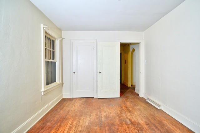 unfurnished bedroom featuring hardwood / wood-style flooring and a closet