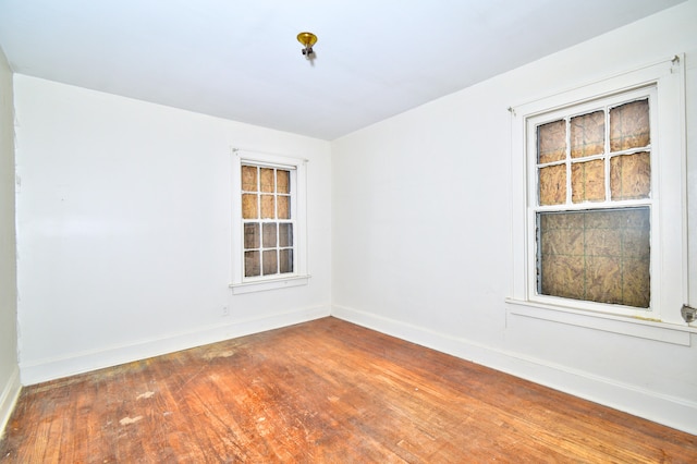 unfurnished room with hardwood / wood-style floors