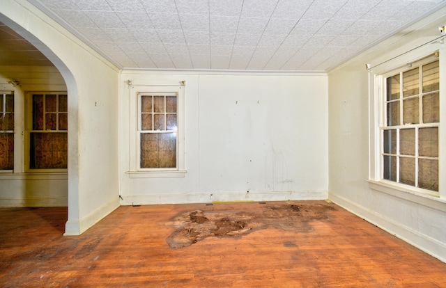 unfurnished room with wood-type flooring and crown molding