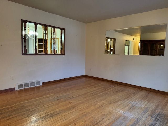 spare room with hardwood / wood-style flooring