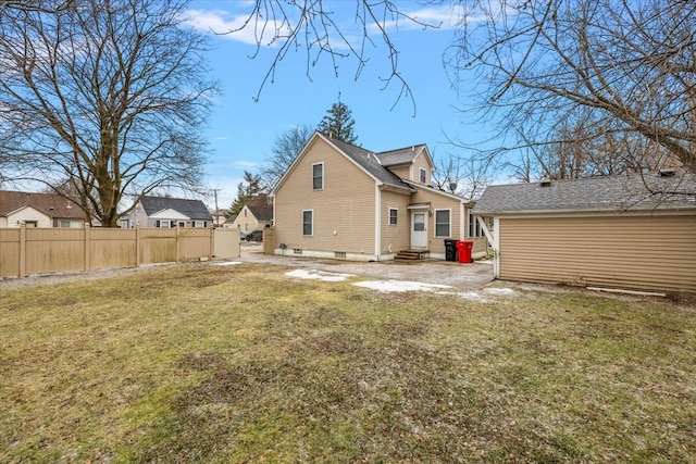 back of house featuring a lawn