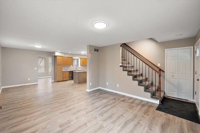 unfurnished living room with light hardwood / wood-style flooring