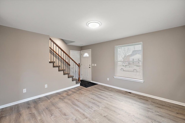 foyer entrance with light wood-type flooring