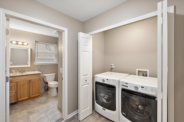 washroom featuring separate washer and dryer and sink