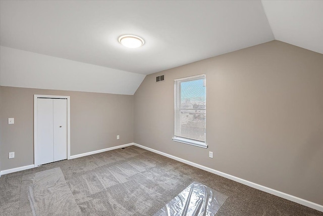 bonus room featuring lofted ceiling and carpet floors