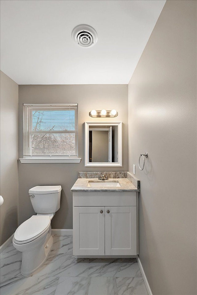 bathroom featuring vanity and toilet