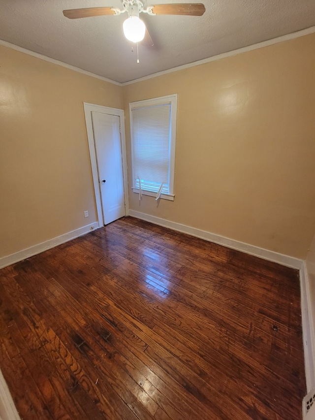 unfurnished room with dark hardwood / wood-style flooring, ceiling fan, ornamental molding, and a textured ceiling