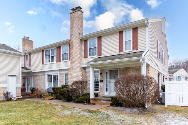 view of front facade with central AC unit and a front yard