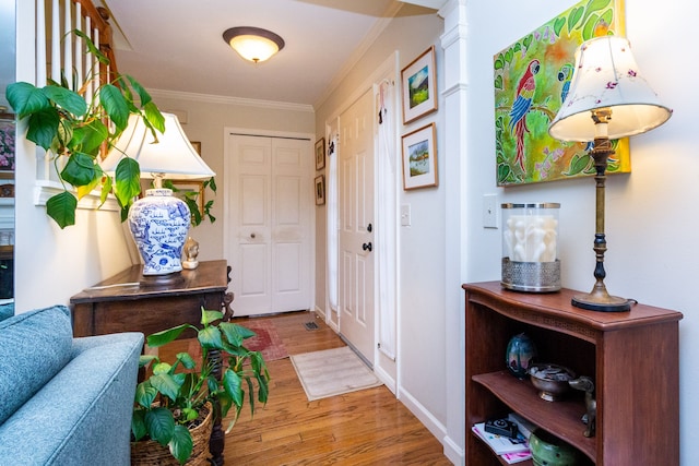 interior space featuring wood-type flooring and ornamental molding