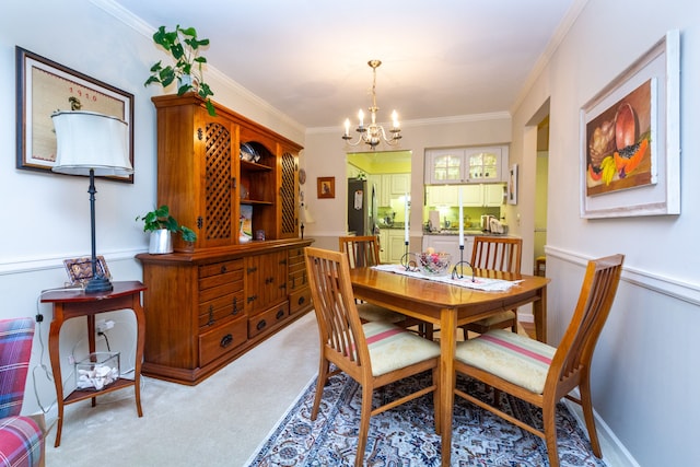 dining room featuring light carpet, a notable chandelier, and ornamental molding