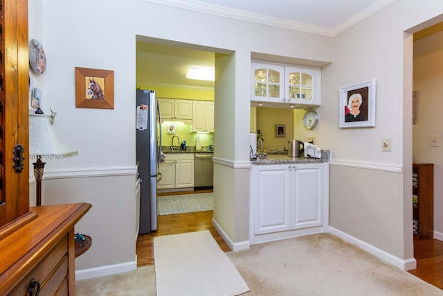 bathroom featuring ornamental molding and sink