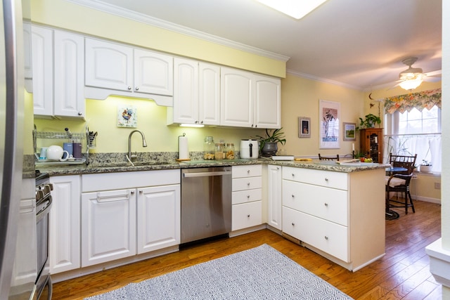 kitchen with white cabinetry, stainless steel appliances, and kitchen peninsula