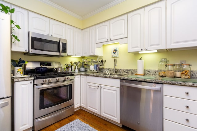 kitchen with sink, white cabinets, and appliances with stainless steel finishes