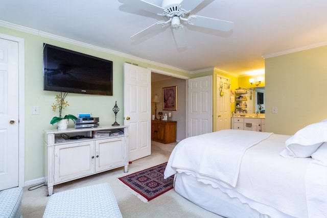 bedroom with crown molding, light colored carpet, ensuite bathroom, and ceiling fan