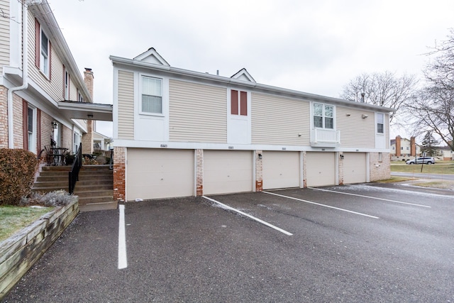 view of vehicle parking featuring a garage