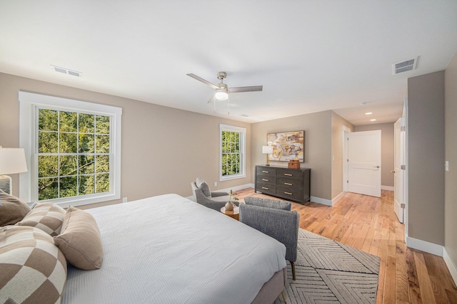 bedroom with light hardwood / wood-style flooring and ceiling fan