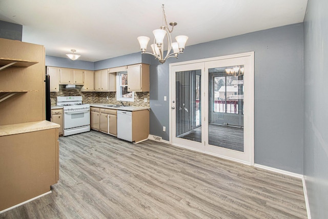 kitchen featuring sink, hanging light fixtures, white appliances, light hardwood / wood-style floors, and decorative backsplash